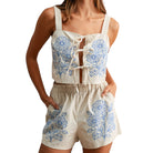 Woman wearing a floral two-piece outfit on a white background