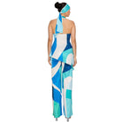 Woman wearing a blue and white patterned jumpsuit with a matching headscarf on a white background