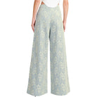 woman wearing floral lace pants with white background