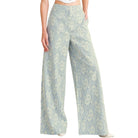 woman wearing floral lace pants with white background
