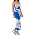 Woman wearing a strapless dress with blue and white floral pattern on a white background