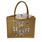 Brown jute bag with decorative bows on a white background
