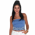Woman wearing a blue top with lace detail on a white background