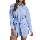 Woman wearing a blue and white striped shirt dress on a white background