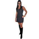 Woman wearing a plaid dress and black boots on a white background