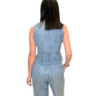 Woman wearing a denim vest on a white background