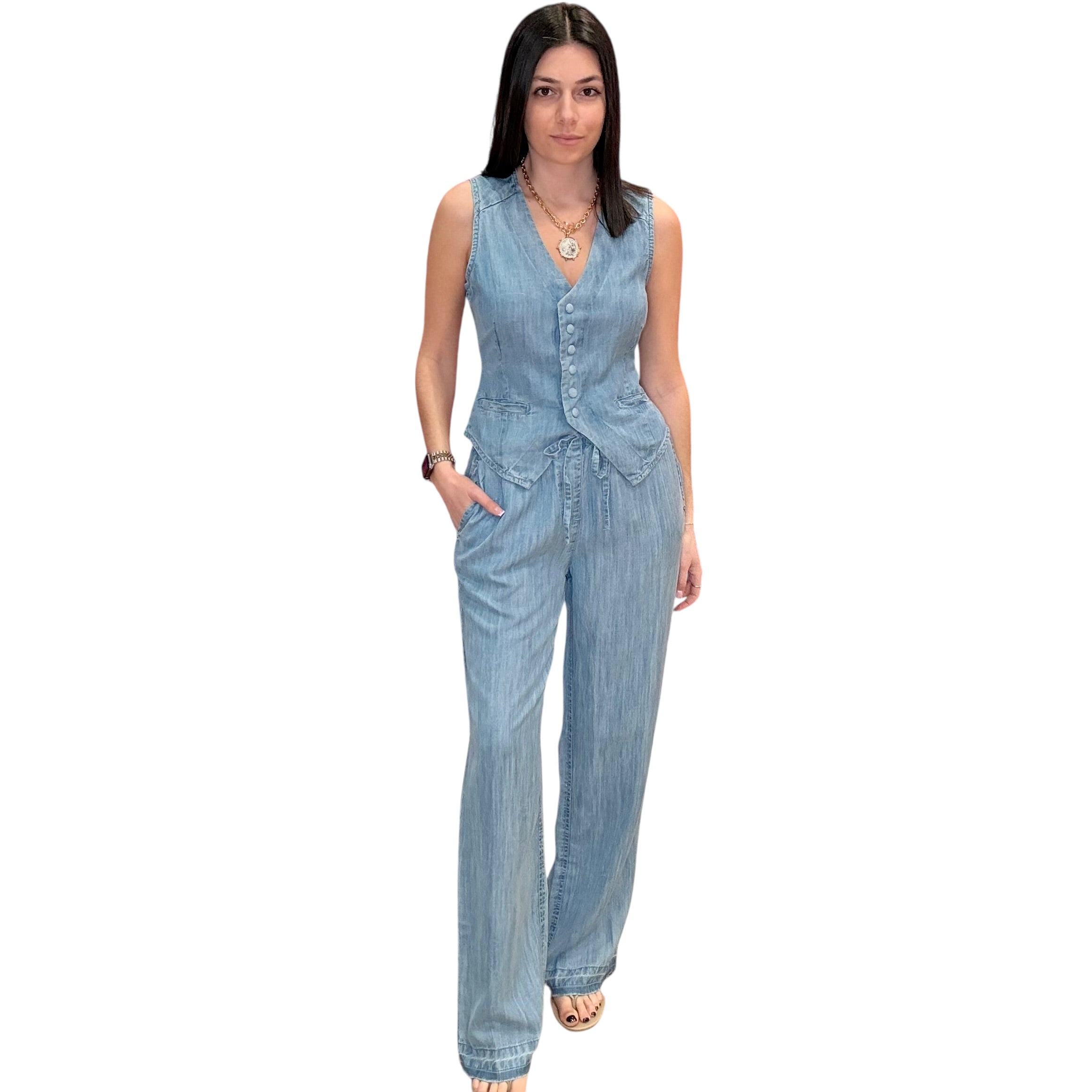 Woman wearing a light blue denim outfit on a white background