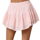 Pink skirt with lace trim on a white background