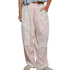 Light pink pants with lace detailing worn by a person on a white background
