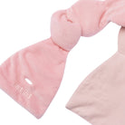 Pink eye mask with a knot on a white background