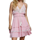 Pink dress with white embroidery and tassels on a white background