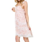 woman wearing pink floral tiered lace mini dress with white background