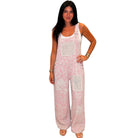 Woman wearing pink floral overalls on a white background