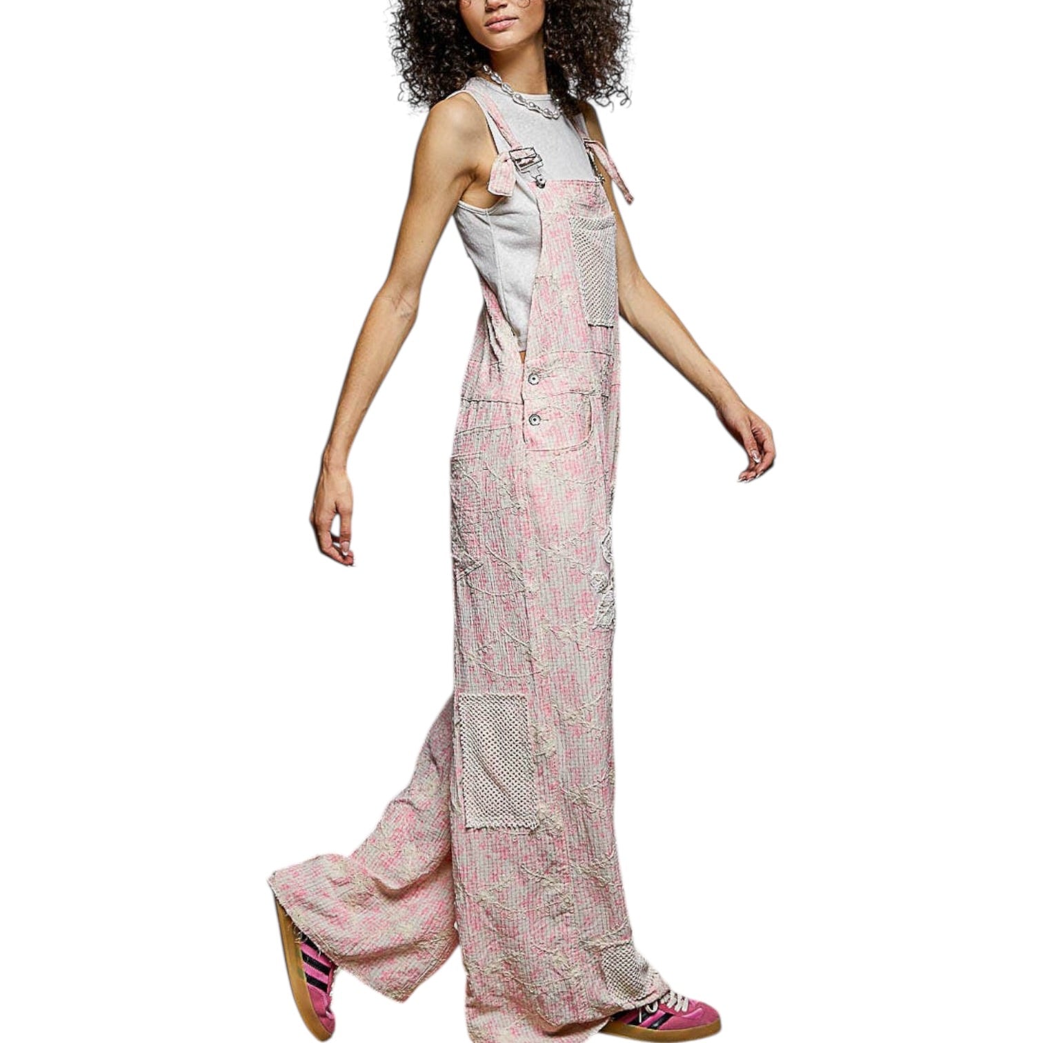 Woman wearing a long, patterned dress on a white background