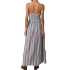 Woman wearing a long striped dress on a white background
