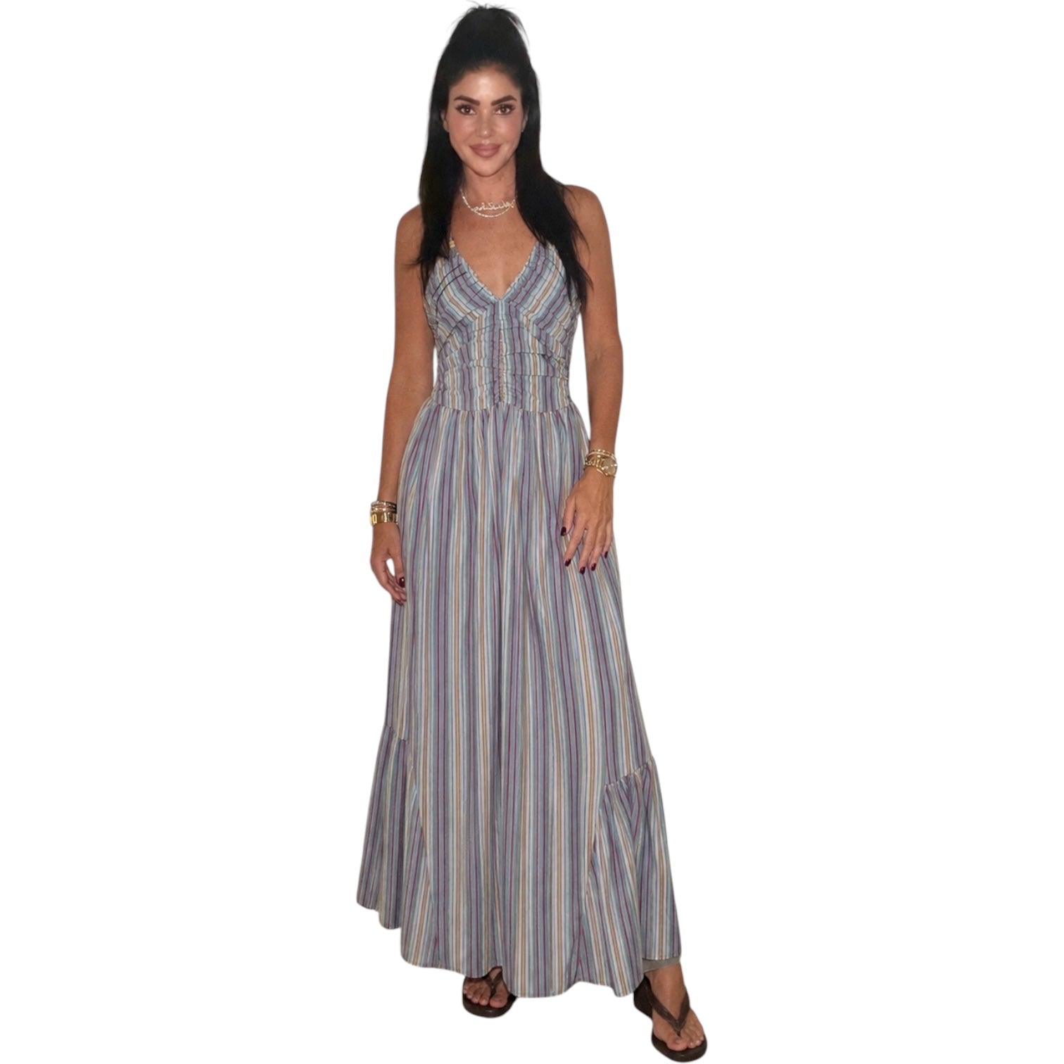 Woman wearing a long striped dress on a white background
