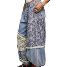 Harem pants with floral pattern and denim accents on a white background