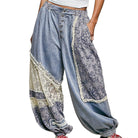Light blue patchwork pants with lace details on a white background