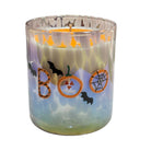 A Halloween-themed candle in a clear glass jar with a marbled blue, purple, and green design. The jar features decorative cutouts spelling 'BOO' with a jack-o'-lantern and spiderweb, along with black bat silhouettes, and a lit orange candle is visible inside.