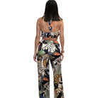 Woman wearing a floral two-piece outfit on a white background