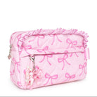 Pink cosmetic bag with bow pattern on a white background