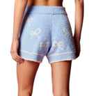 Light blue shorts with white patterns on a white background