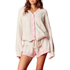 Woman wearing a pink and white fluffy set on a white background