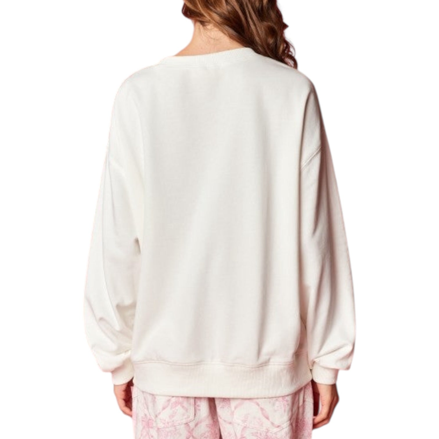 Person wearing a white sweatshirt with a plain background