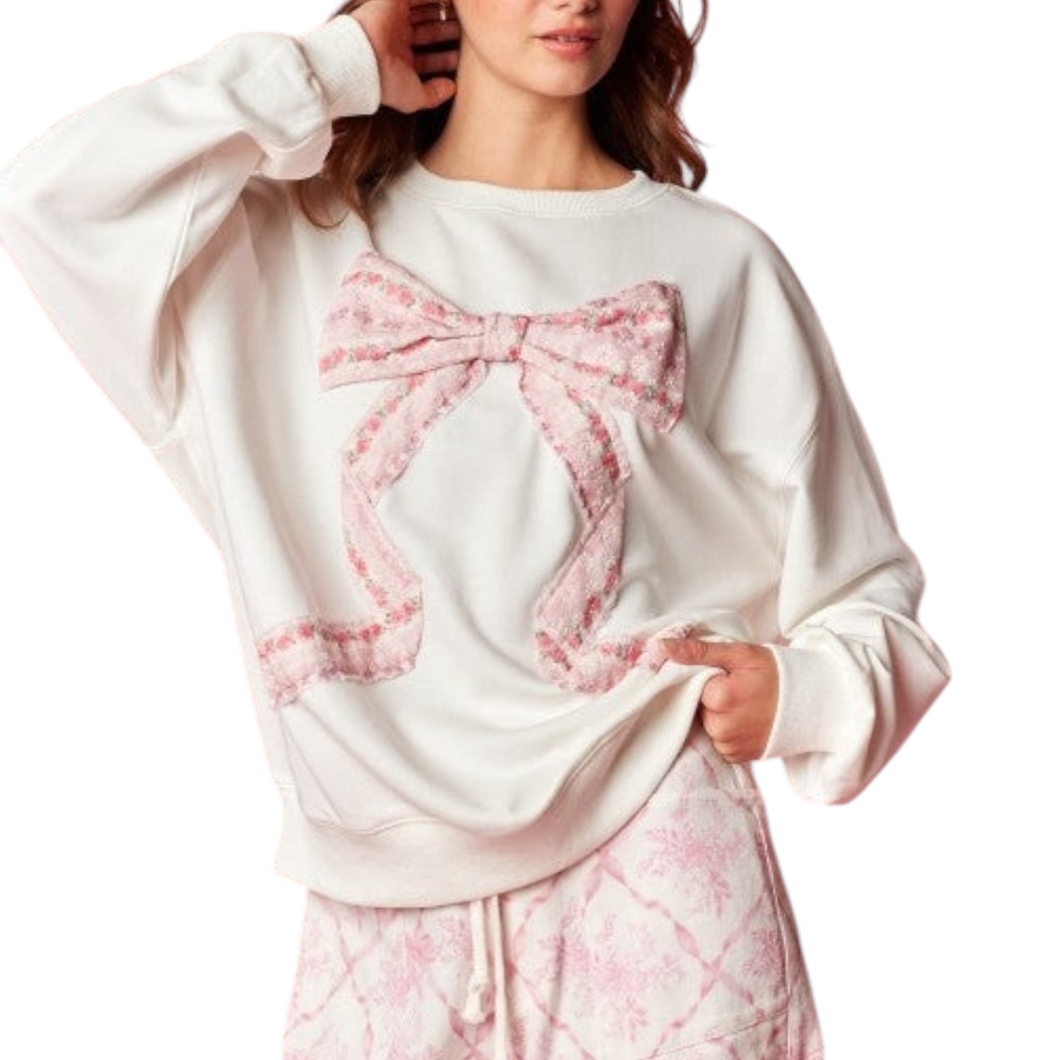 White sweatshirt with a pink bow design on a white background