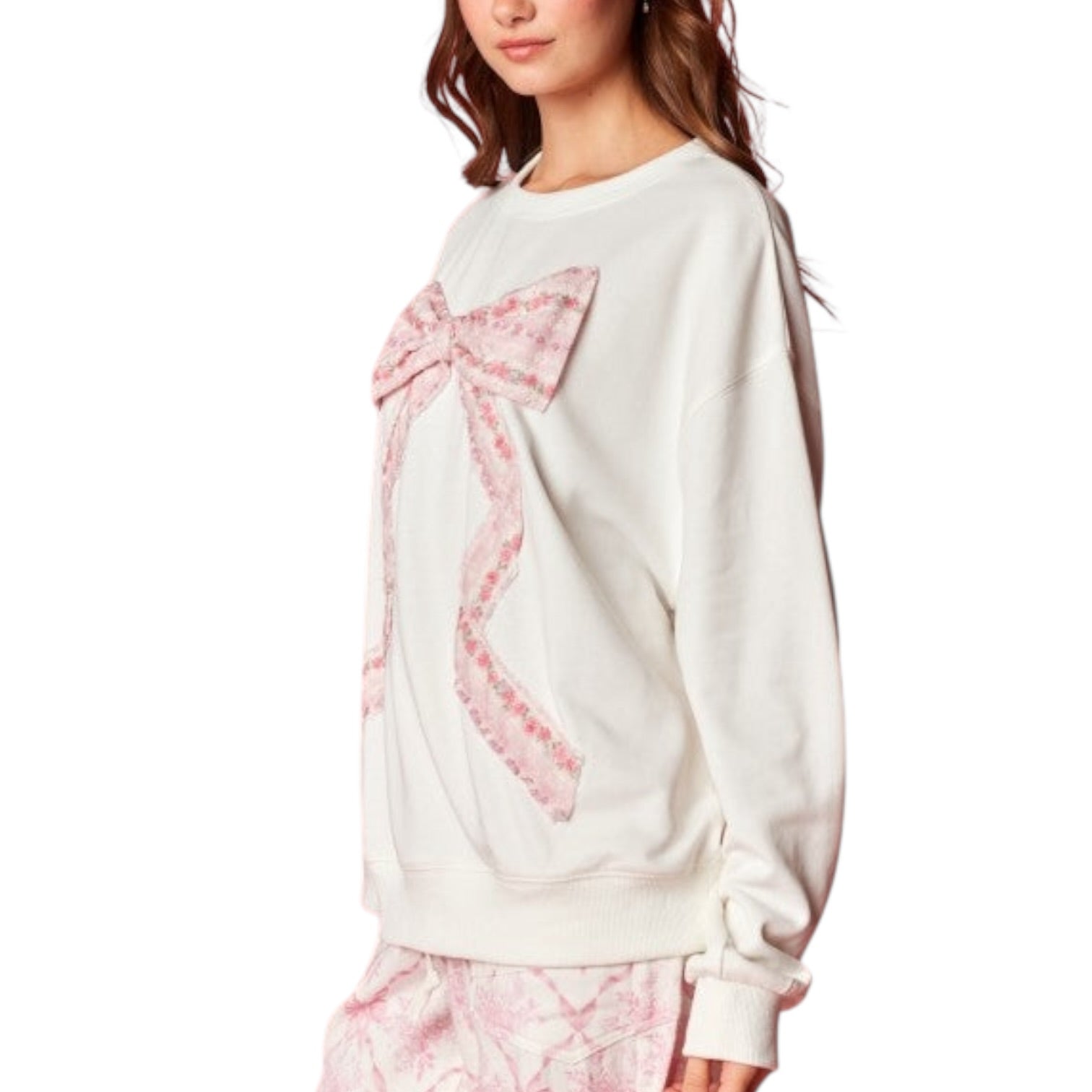 White sweatshirt with pink floral design on a white background