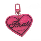Pink glitter heart-shaped keychain with 'Brat' text on a white background