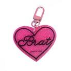 Pink glitter heart-shaped keychain with 'Brat' text on a white background