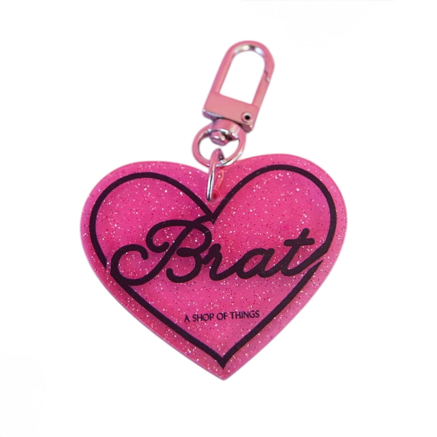 Pink glitter heart-shaped keychain with 'Brat' text on a white background