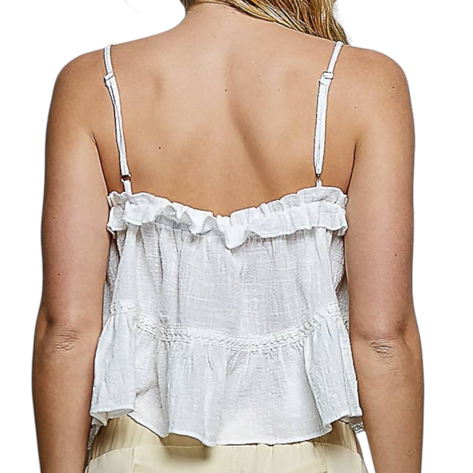 White lace top worn by a person on a white background