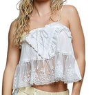 White lace top worn by a person on a white background