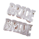 Two 'Bride' hair clips with rhinestone embellishments on a white background