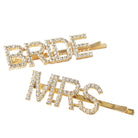 Gold hair pins with 'BRIDE' and 'MRS' text on a white background