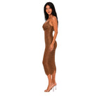 A woman modeling a ruched, one-shoulder midi dress in a metallic bronze-brown color, paired with clear high-heeled sandals, set against a plain white background.