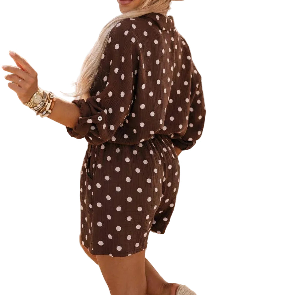 Woman in a polka dot dress and hat standing on a street.