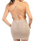 Beige dress with criss-cross straps on a white background