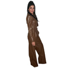 Woman wearing a brown leather pant set on a white background