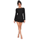 A woman modeling a black long-sleeve mini dress with a wide boat neckline and a ruffled hem, shown against a plain white background.