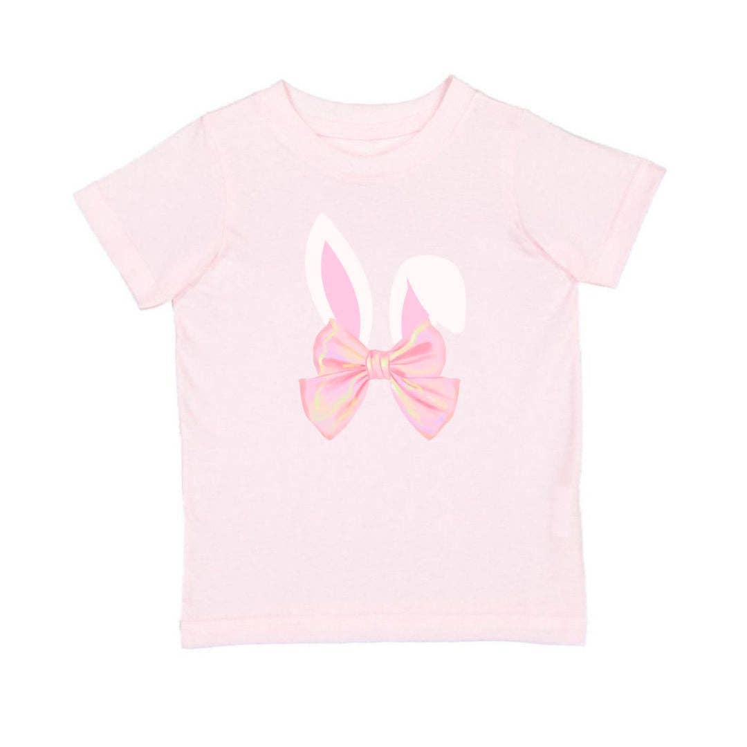 Pink t-shirt with a bow design on a white background