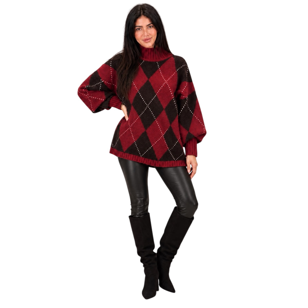 A woman modeling a red and black argyle knit turtleneck sweater with balloon sleeves, paired with black faux-leather pants and black knee-high boots, against a plain white background.