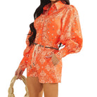 Orange patterned set worn by a person on a white background