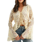 Woman wearing a beige lace top with long sleeves on a white background