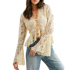 Woman wearing a lace top and jeans on a white background