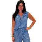 Woman wearing a denim set on a white background