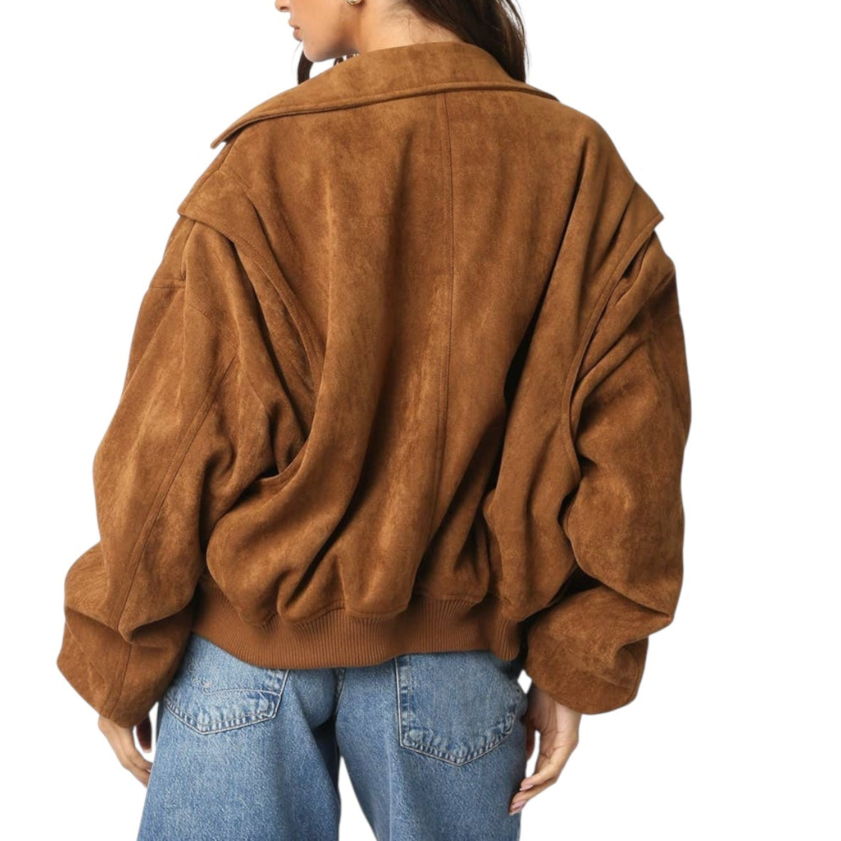 Person wearing a brown suede jacket and blue jeans on a white background