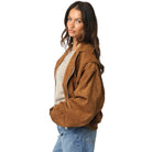 Woman wearing a brown jacket on a white background